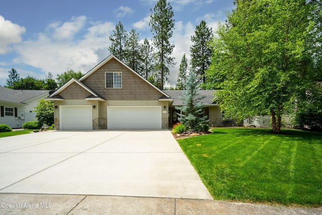 5188 E Twila Ct, Post Falls, ID 83854 - craftsman-style home featuring stone siding, concrete driveway, a front yard, and a garage