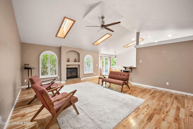 5188 E Twila Ct, Post Falls, ID 83854 - living room with lofted ceiling, a skylight, a tile fireplace, a ceiling fan, and healthy amount of natural light