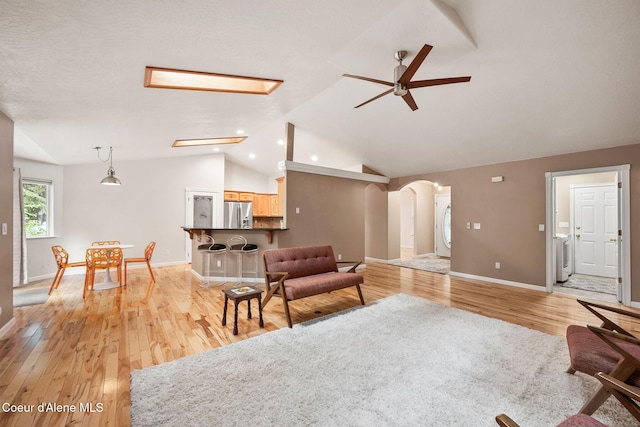 5188 E Twila Ct, Post Falls, ID 83854 - living room with a ceiling fan, arched walkways, light wood-style flooring, vaulted ceiling, and recessed lighting