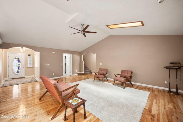 5188 E Twila Ct, Post Falls, ID 83854 - living area with arched walkways, lofted ceiling, stairway, light wood-style flooring, and ceiling fan