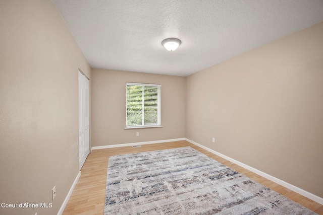 5188 E Twila Ct, Post Falls, ID 83854 - unfurnished room featuring light wood-style flooring and a textured ceiling