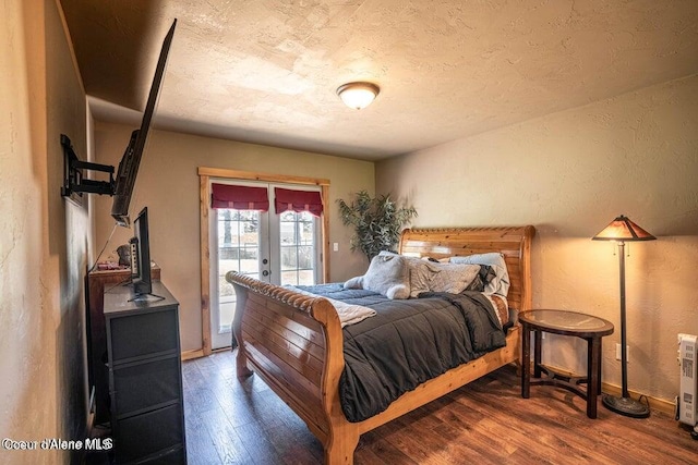 11 Elk Horn, Clark Fork, ID 83811 - bedroom featuring french doors, access to exterior, wood finished floors, a textured wall, and a textured ceiling