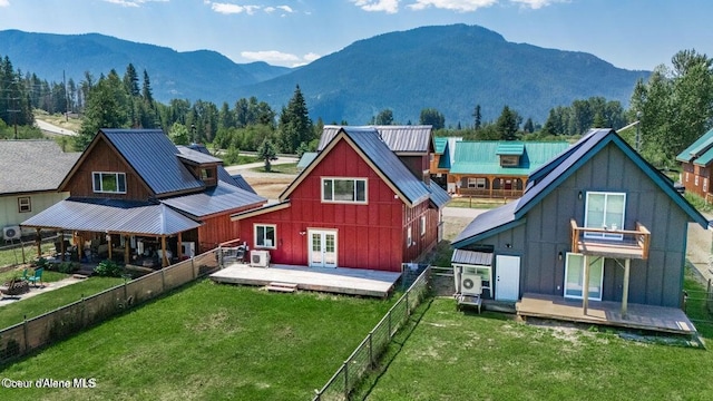 11 Elk Horn, Clark Fork, ID 83811 - back of house with board and batten siding, a deck with mountain view, a fenced backyard, french doors, and a metal roof
