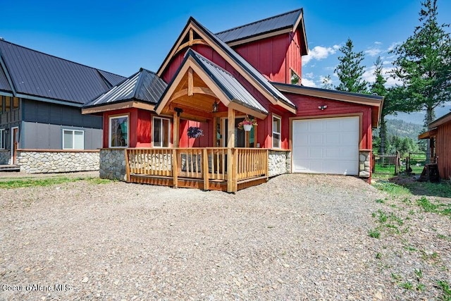11 Elk Horn, Clark Fork, ID 83811 - view of front facade featuring stone siding, an attached garage, gravel driveway, and a metal roof