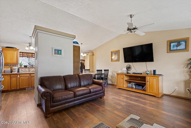 3569 E Jordan Dr, Post Falls, ID 83854 - living room featuring wood-type flooring, ceiling fan, a chandelier, lofted ceiling, and a textured ceiling