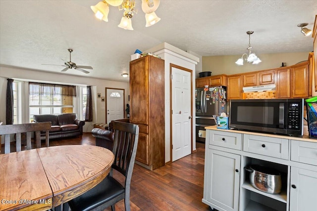 3569 E Jordan Dr, Post Falls, ID 83854 - kitchen featuring a chandelier, stainless steel refrigerator with ice dispenser, black microwave, dark wood finished floors, and open floor plan