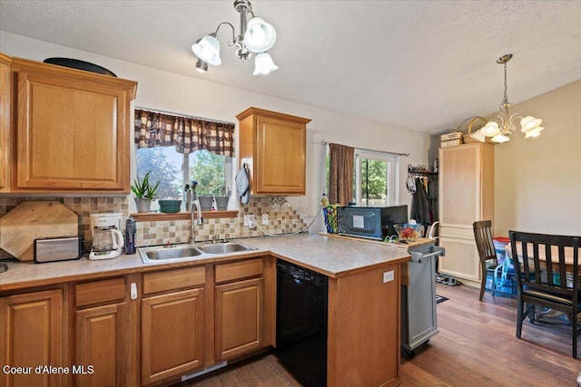 3569 E Jordan Dr, Post Falls, ID 83854 - kitchen with a chandelier, decorative backsplash, a peninsula, light countertops, and a textured ceiling