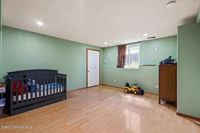 3569 E Jordan Dr, Post Falls, ID 83854 - unfurnished bedroom with wood finished floors and recessed lighting