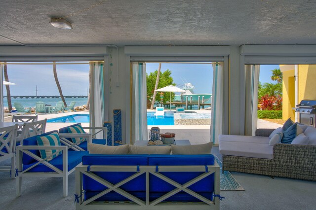 living room with a water view and a textured ceiling