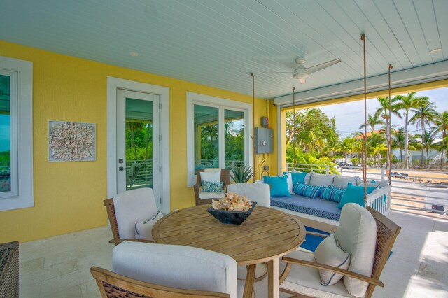 sunroom featuring ceiling fan