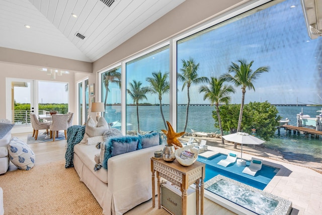 sunroom / solarium with lofted ceiling, wood ceiling, and a water view