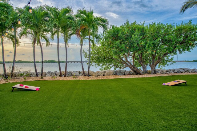 view of home's community featuring a water view and a yard