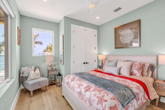 bedroom with light wood-type flooring and a closet