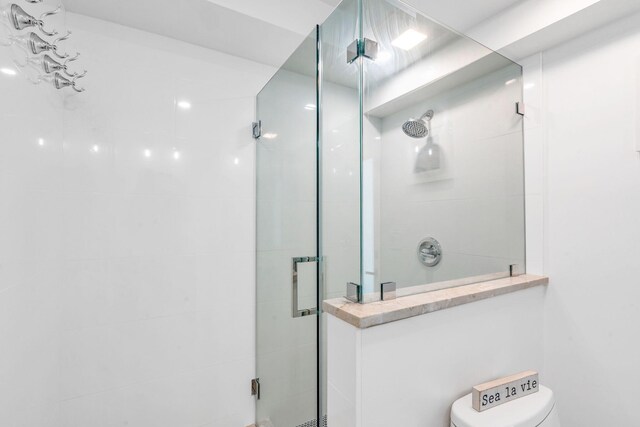 bathroom with walk in shower and toilet