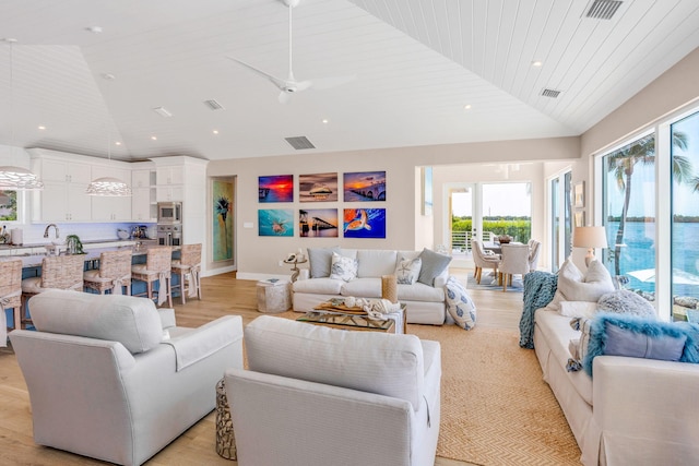 living room with ceiling fan, lofted ceiling, wooden ceiling, and light hardwood / wood-style floors