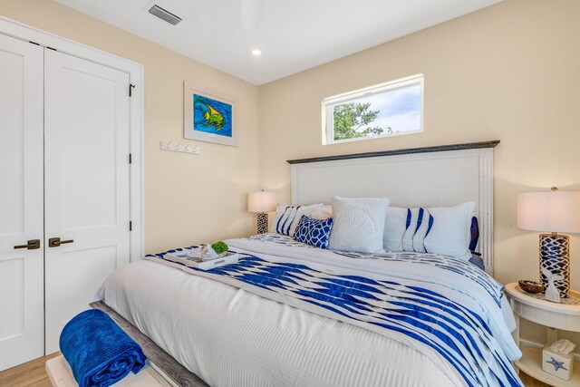 bedroom featuring wood-type flooring and a closet