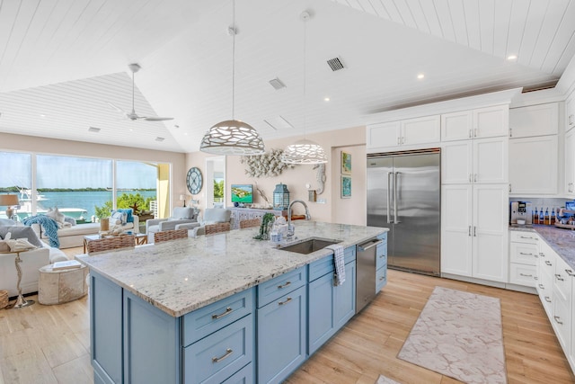 kitchen with sink, white cabinetry, wood ceiling, appliances with stainless steel finishes, and a kitchen island with sink