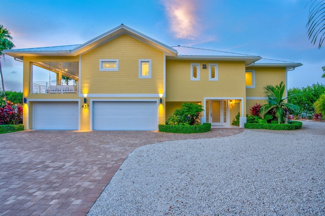 view of front facade with a garage and a balcony