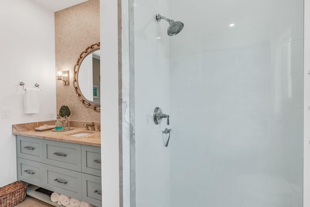 bathroom with vanity and a tile shower