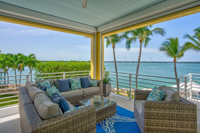 exterior space with a water view and outdoor lounge area