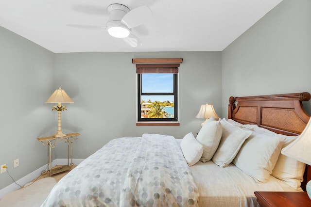 bedroom with ceiling fan and baseboards