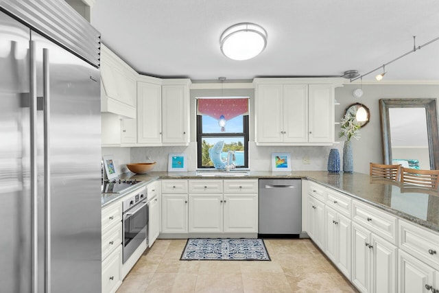 kitchen featuring tasteful backsplash, a sink, white cabinetry, stainless steel appliances, and stone countertops