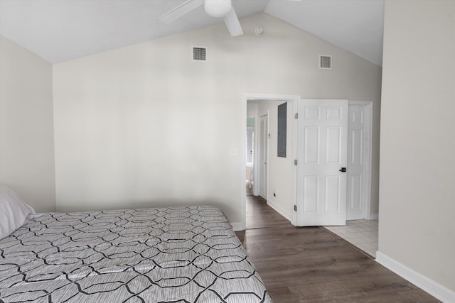 unfurnished bedroom with ceiling fan, lofted ceiling, electric panel, and dark hardwood / wood-style flooring