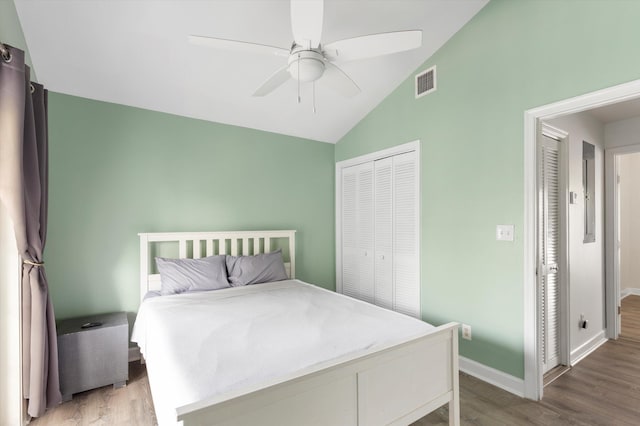 bedroom featuring ceiling fan, a closet, vaulted ceiling, and hardwood / wood-style floors