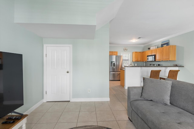 living room with ornamental molding and light tile patterned floors