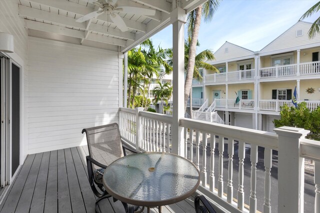 wooden balcony featuring a wooden deck and ceiling fan