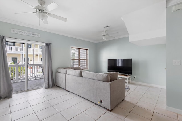 living room featuring ornamental molding, light tile patterned floors, and ceiling fan