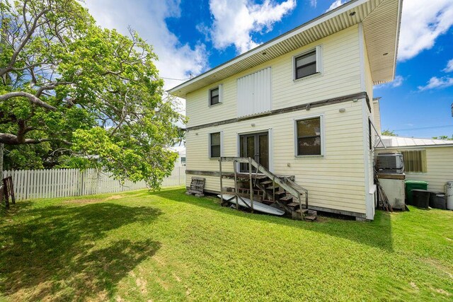 back of house featuring a yard