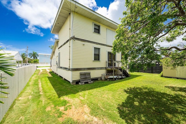 back of house with a lawn