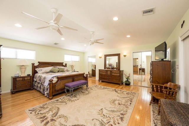 bedroom featuring lofted ceiling, ceiling fan, and light hardwood / wood-style flooring