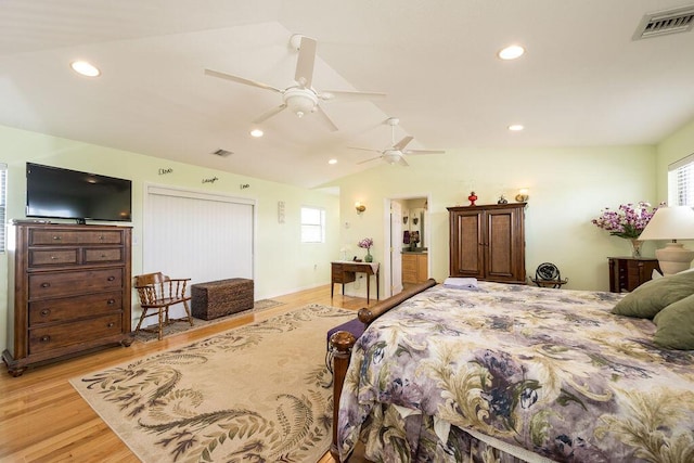 bedroom featuring ceiling fan, lofted ceiling, and light wood-type flooring