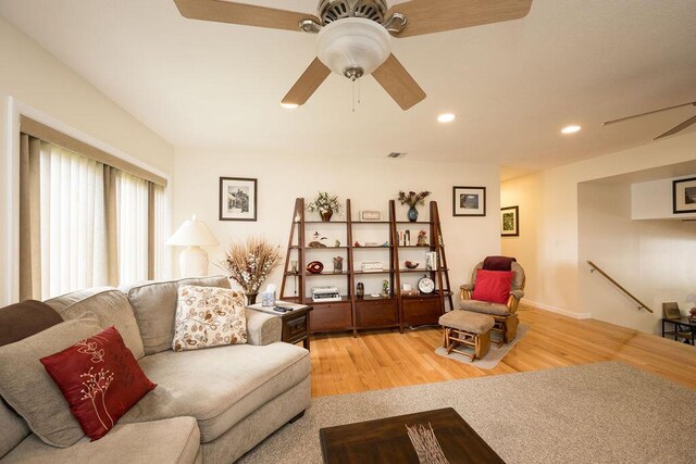 living room featuring hardwood / wood-style flooring and ceiling fan