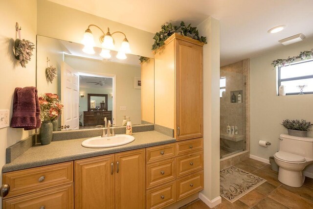 bathroom with walk in shower, vanity, toilet, and tile patterned flooring