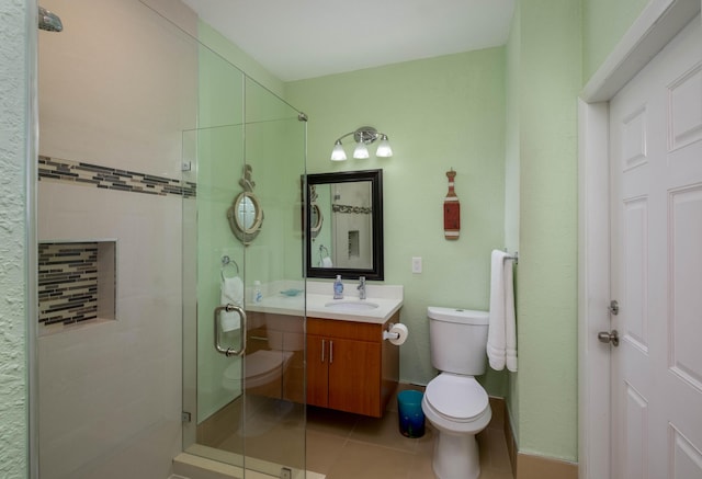 bathroom with vanity, toilet, tile patterned flooring, and a shower stall