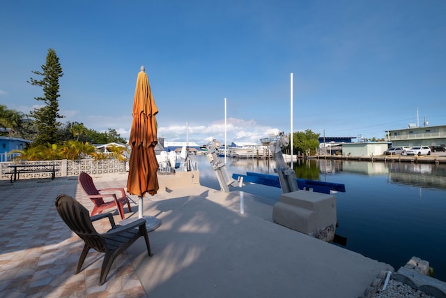 view of dock featuring boat lift and a water view
