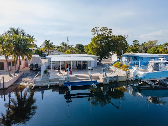 view of dock featuring boat lift and a water view