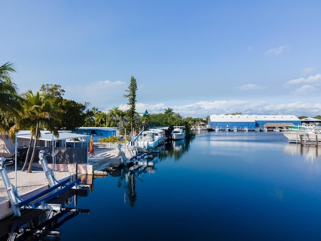 dock area with a water view and boat lift