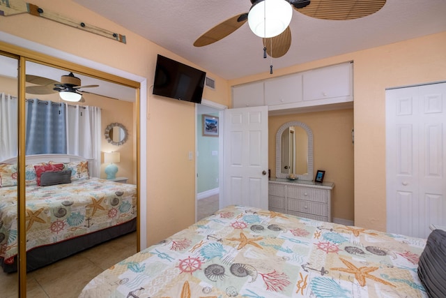 tiled bedroom with a closet and a ceiling fan
