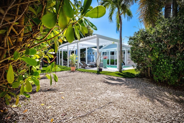 view of yard with a patio, an outdoor pool, and a pergola