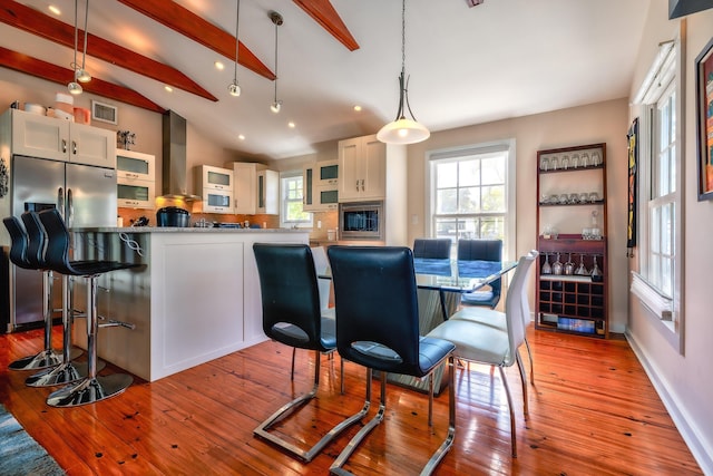 dining area featuring visible vents, baseboards, wood-type flooring, vaulted ceiling with beams, and recessed lighting