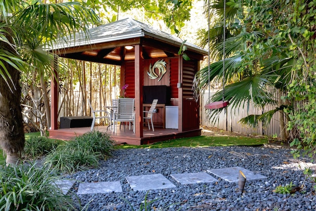 view of outdoor structure featuring a gazebo and fence