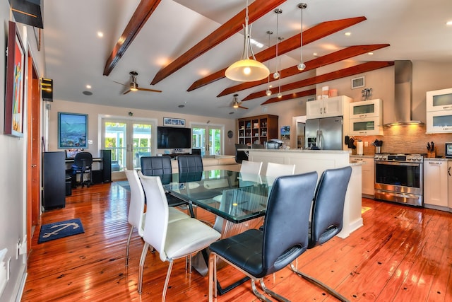 dining room with lofted ceiling with beams, hardwood / wood-style flooring, visible vents, and french doors