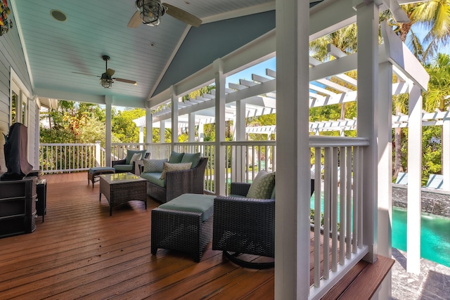 wooden terrace with outdoor lounge area and a ceiling fan