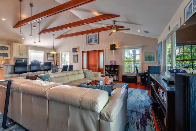 living room with a wealth of natural light, beam ceiling, high vaulted ceiling, and wood finished floors