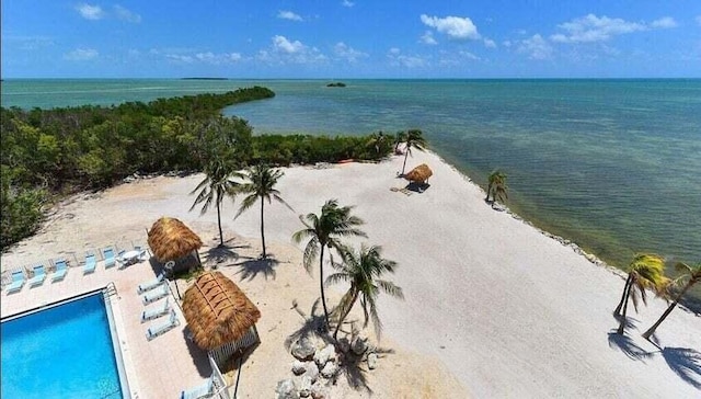 aerial view with a water view and a beach view