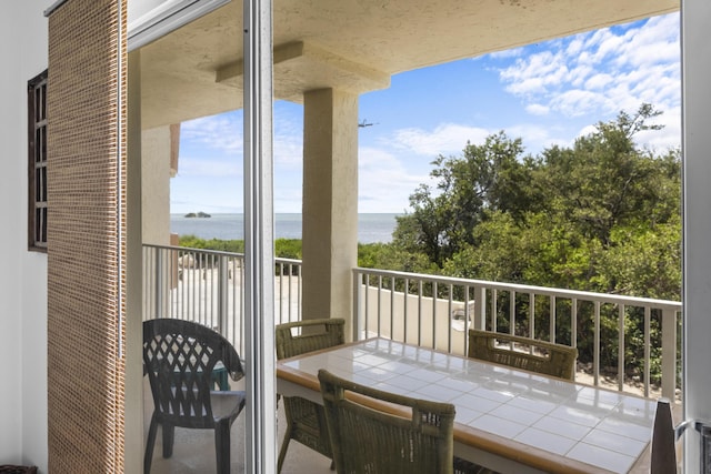 balcony featuring a water view